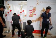 Uniforms for torchbearers of the Tokyo 2020 Olympic Games, and route maps of the torch relay are displayed at a Torch Relay event to mark the 300-day milestone to the starting date of the torch relay, in Tokyo