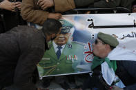 People gather during the funeral Gen. Ahmed Gaid Salah, in Algiers, Algeria, Wednesday, Dec. 25, 2019. Algeria is holding an elaborate military funeral for the general who was the de facto ruler of the gas-rich country amid political turmoil throughout this year. (AP Photo/Toufik Doudou)