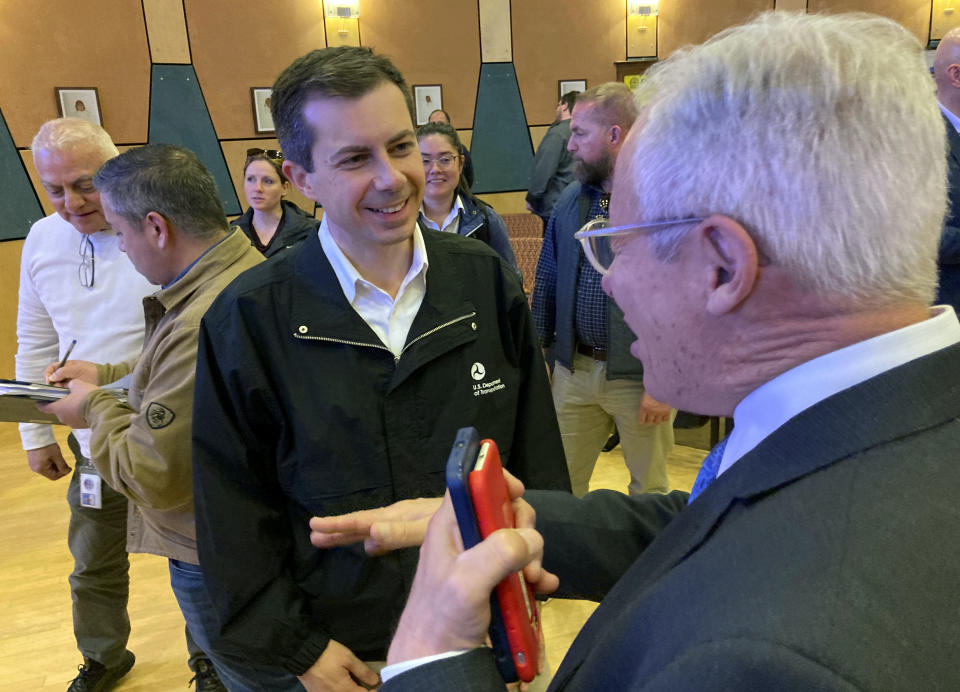 U.S. Transportation Secretary Pete Buttigieg, center, talks with New Mexico infrastructure adviser Martin Chavez, right, following a news conference in Santa Ana Pueblo, N.M., on Tuesday, April 4, 2023. Buttigieg announced a new pilot project for financing wildlife crossing corridors along busy highways around the U.S. during his visit. (AP Photo/Susan Montoya Bryan)