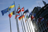 The Ukrainian flag, top, floats outside the European Parliament before a commission on Russia's escalation of its war of aggression against Ukraine, at the European Parliament, Wednesday, Oct. 5, 2022, in Strasbourg, eastern France. (AP Photo/Jean-Francois Badias)