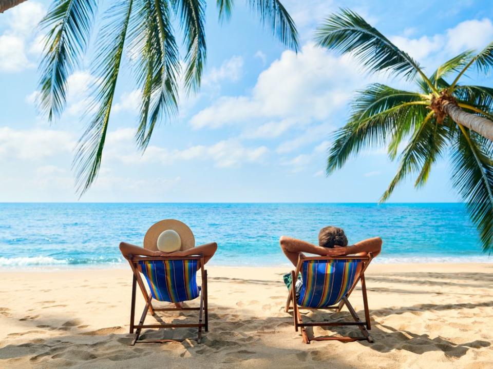 Couple relax on the beach enjoy beautiful sea on the tropical island