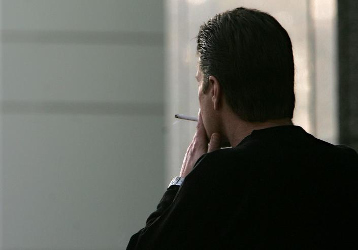 In this Dec. 13, 2005, file photo, an unidentified man smokes a cigarette in Sacramento, Calif. The adult smoking rate fell in 2015, with its largest annual decline in at least 20 years. By 2022, rates of U.S. cigarette smokers had hit all-time lows, according to a new report (AP Photo/Rich Pedroncelli, File)