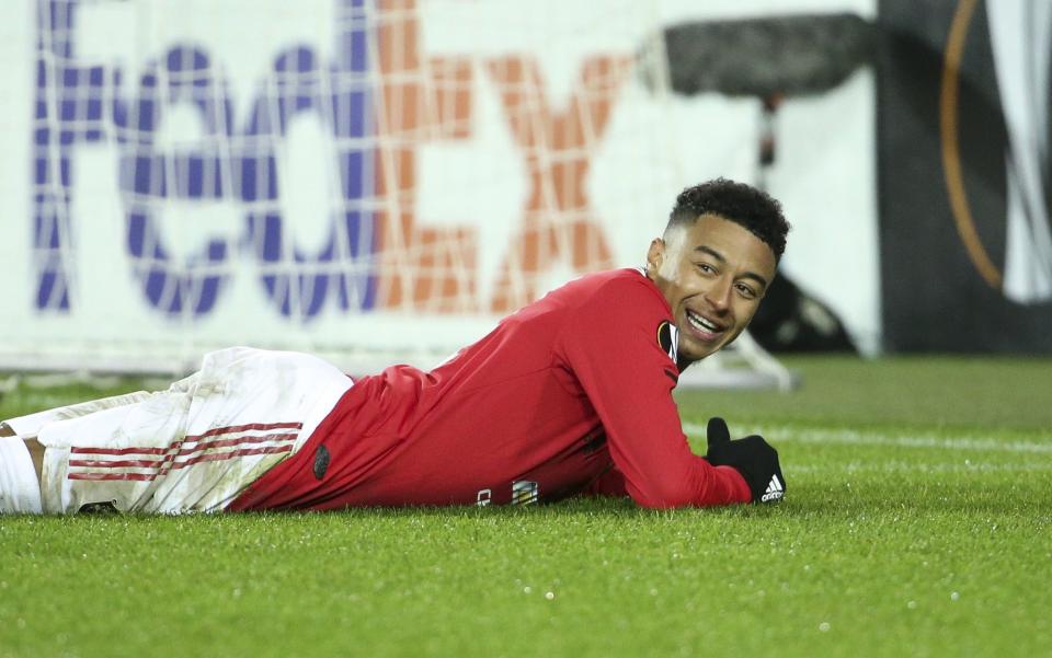 Jesse Lingard lies on the pitch smiling - GETTY IMAGES