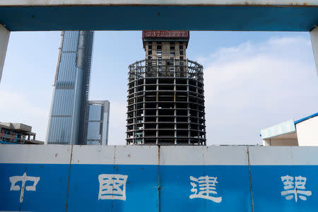 A construction site fence surrounds the site of the Goldin Finance 117 skyscraper in Tianjin's high-tech zone, China, May 25, 2018. REUTERS/Yawen Chen