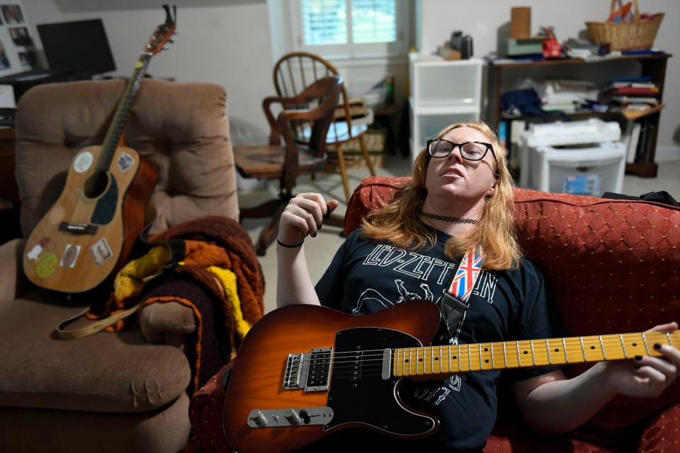 Rebekah Farlow, 26, plays guitar in her family home where she lives in Simpsonville, S.C., on Monday, June 2, 2023. Farlow is a musician, comedian and writer who is pursuing her passions through her recover for drug addiction. 