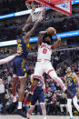 Chicago Bulls guard Coby White, right, shoots against Indiana Pacers forward Jalen Smith during the first half of an NBA basketball game in Chicago, Wednesday, March 27, 2024. (AP Photo/Nam Y. Huh)