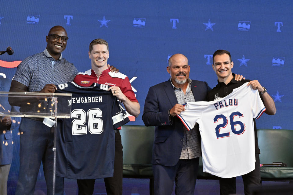 From left, former NFL player DeMarcus Ware, IndyCar driver Josef Newgarden, former baseball player Pudge Rodriguez and IndyCar driver Alex Palou pose for a group photo during a news conference announcing the IndyCar Grand Prix of Arlington to be held in 2026 in Arlington, Texas, Tuesday, Oct. 8, 2024. (AP Photo/Jerome Miron)