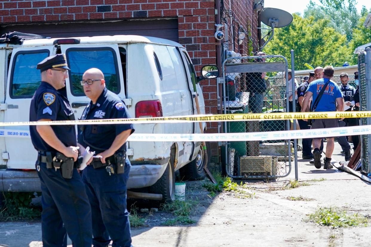 Emergency service personnel work at the scene of a basement apartment where bodies were found on Peck Ave. in the Flushing neighborhood of the Queens borough of New York, Thursday, Sept. 2, 2021, in New York.