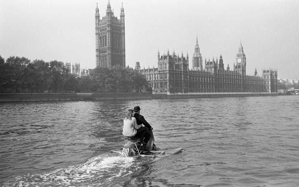 Water scootering back to the office after lunch? It was 'skipper' businessman Jack Hornsby, with his 17 year old daughter Stella sailing pillion, during a try out on the River Thames, London. It is an amphibious motor scooter fitted with two floats which are let down before entering the water. A paddle fixed to the back wheel, and it is steered by a rudder controlled by the handlebars 20th October 1965 U9429 . (Photo by George Greenwell/Mirrorpix/Getty Images) - Getty