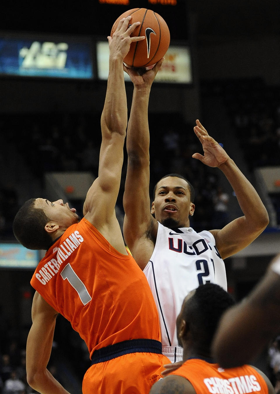 Syracuse's Michael Carter-Williams, left, blocks a shot-attempt by Connecticut's Omar Calhoun, right, during the second half of an NCAA college basketball game in Hartford, Conn., Wednesday, Feb. 13, 2013. Connecticut won 66-58. (AP Photo/Jessica Hill)