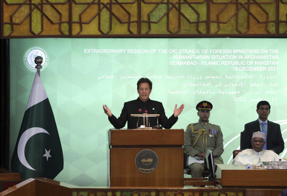 Pakistan Prime Minister Imran Khan, center, speaks during the 17th extraordinary session of Organization of Islamic Cooperation (OIC) Council of Foreign Ministers, in Islamabad, Pakistan, Sunday, Dec. 19, 2021. The economic collapse of Afghanistan, already teetering dangerously on the edge, would have a "horrendous" impact on the region and the world, successive speakers warned Sunday at the start of a one-day summit of foreign ministers. (AP Photo/Rahmat Gul)