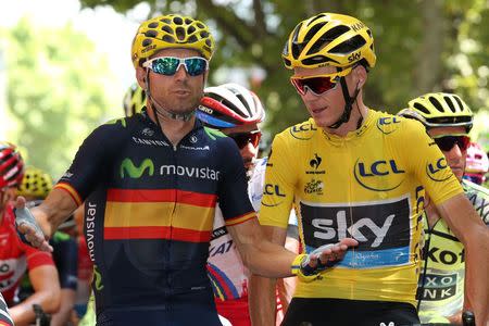 Movistar rider Alejandro Valverde of Spain (L) talks with Team Sky rider Chris Froome of Britain, race leader's yellow jersey, before the start of the 161-km (100 miles) 17th stage of the 102nd Tour de France cycling race from Digne-les-Bains to Pra Loup, France, July 22, 2015. REUTERS/Stefano Rellandini