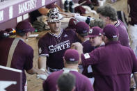 Mississippi State's Logan Tanner, center left, celebrates with teammates after hitting a second-inning three-run home run against Notre Dame during an NCAA college baseball super regional game, Monday, June 14, 2021, in Starkville, Miss. (AP Photo/Rogelio V. Solis)