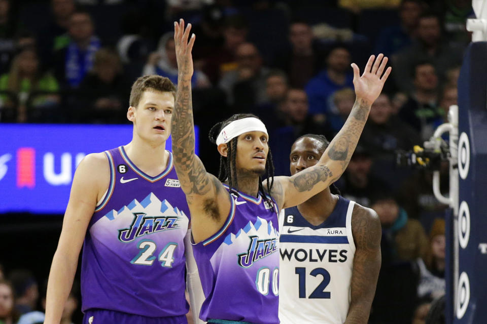 Utah Jazz guard Jordan Clarkson (00) celebrates after a basket as Jazz center Walker Kessler (24) and Minnesota Timberwolves forward Taurean Prince (12) look on in the third quarter during an NBA basketball game Monday, Jan. 16, 2023, in Minneapolis. (AP Photo/Andy Clayton-King)