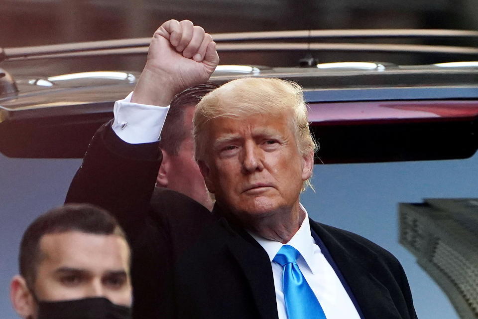 Former U.S. President Donald Trump acknowledges people as he gets in his SUV outside Trump Tower in the Manhattan borough of New York City, New York, U.S., March 9, 2021. REUTERS/Carlo Allegri     TPX IMAGES OF THE DAY