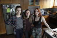 Rebecca Sirull, center, poses for a photo with her roommates, Anna Thomas, left, and Madeleine Busch, Monday, March 16, 2020, at the home they share in Seattle. Earlier in the day, Sirull was the third person to receive a shot of a potential vaccine for the COVID-19 coronavirus at the start of the first-stage safety study clinical trial of the vaccine at the Kaiser Permanente Washington Health Research Institute in Seattle. (AP Photo/Ted S. Warren)
