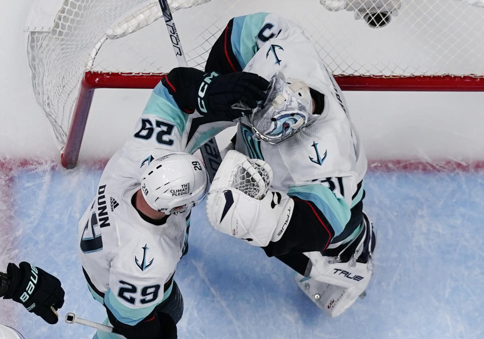 Seattle Kraken goaltender Philipp Grubauer (31) is congratulated by Vince Dunn (29) after the team's win over the Colorado Avalanche in Game 1 of a first-round NHL hockey playoff series Tuesday, April 18, 2023, in Denver (AP Photo/Jack Dempsey)