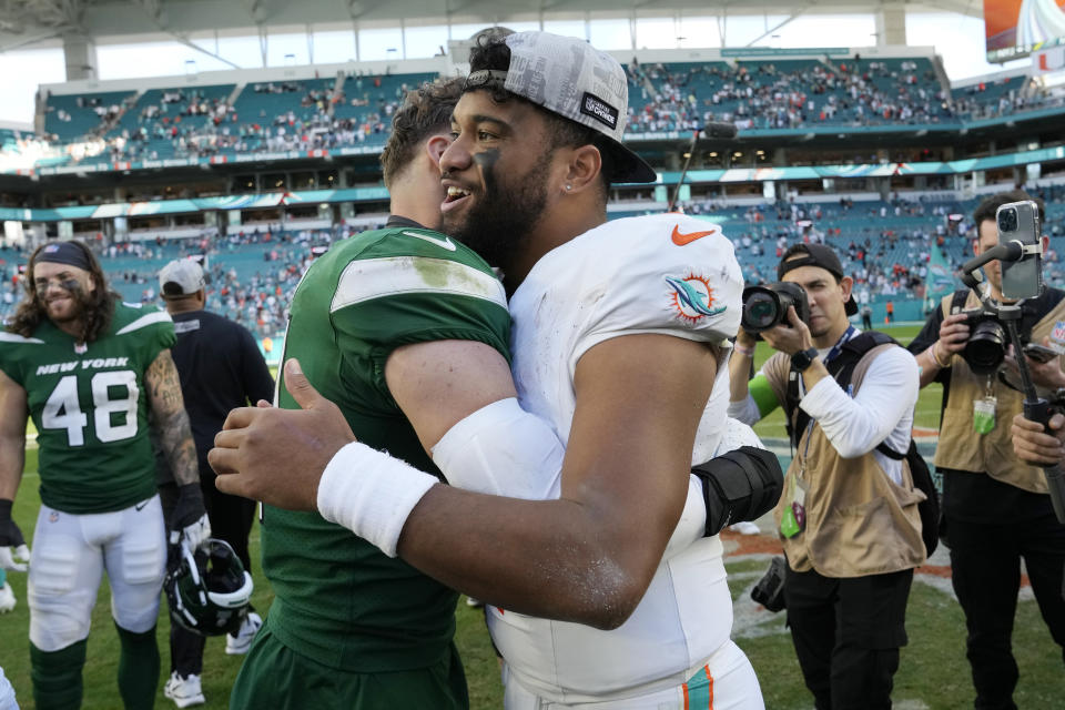 Miami Dolphins quarterback Tua Tagovailoa hugs New York Jets safety Ashtyn Davis at the end of an NFL football game, Sunday, Dec. 17, 2023, in Miami Gardens, Fla. The Dolphins defeated the Jets 30-0. (AP Photo/Lynne Sladky)