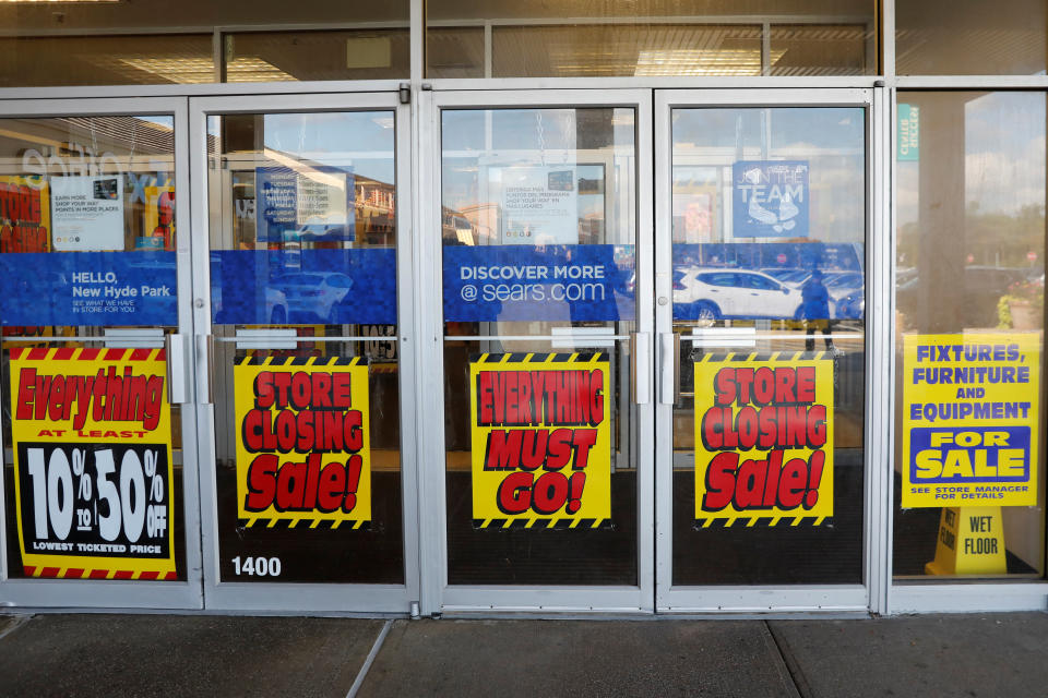 Signs advertising store closing sales are seen on the doors of a Sears in New Hyde Park, New York, U.S., October 10, 2018. REUTERS/Shannon Stapleton