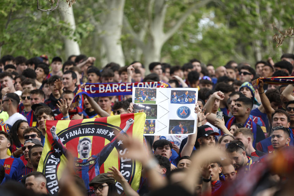 Barcelona supporters wait for the team arrival at the Olimpic Lluis Companys stadium for the Champions League quarterfinal second leg soccer match between Barcelona and Paris Saint-Germain in Barcelona, Spain, Tuesday, April 16, 2024. (AP Photo/Joan Monfort)