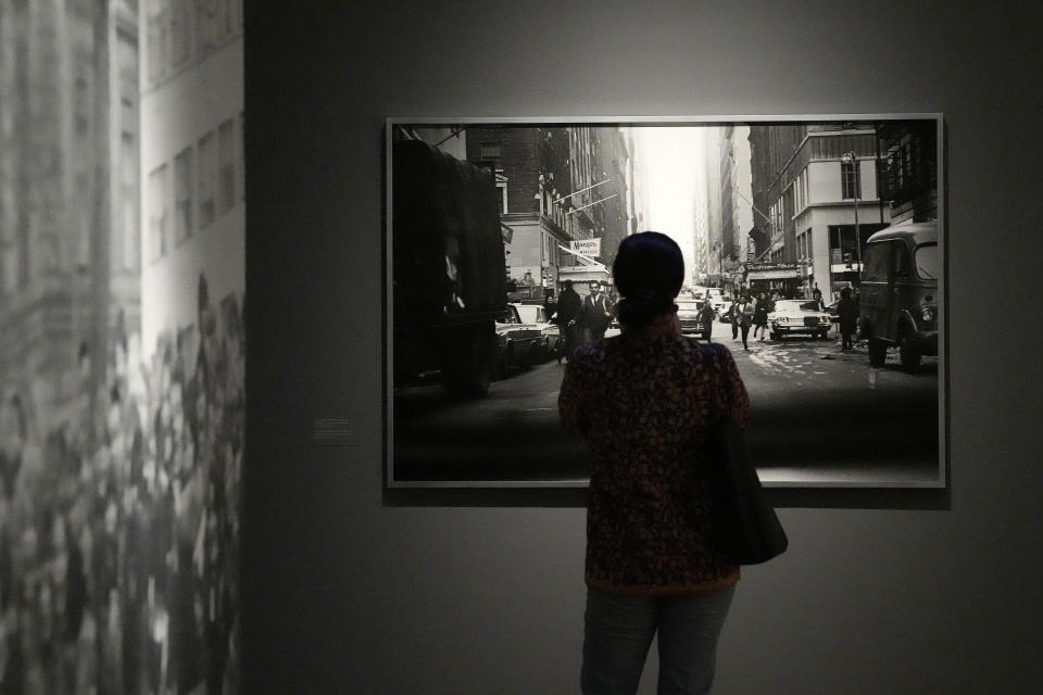 A visitor looks at pictures during a preview of Paul McCartney Photographs 1963-64: Eyes of the Storm exhibition at the National Portrait Gallery in London, Britain, Tuesday, June 27, 2023. The exhibition consists of unseen photographs taken by Paul McCartney from the Beatles at the height of Beatlemania. The gallery will open it's doors from June 28, 2023 until October 1, 2023. (AP Photo/Frank Augstein)