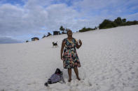 A woman prays in an area of the Abaete dune system, on a steep rise of sand evangelicals have come to call the "Holy Mountain", in Salvador, Brazil, Tuesday, Sept. 13, 2022. Evangelicals have been converging on the dunes for some 25 years but especially lately, with thousands now coming each week to sing, pray and enter trancelike states to commune with God.(AP Photo/Rodrigo Abd)
