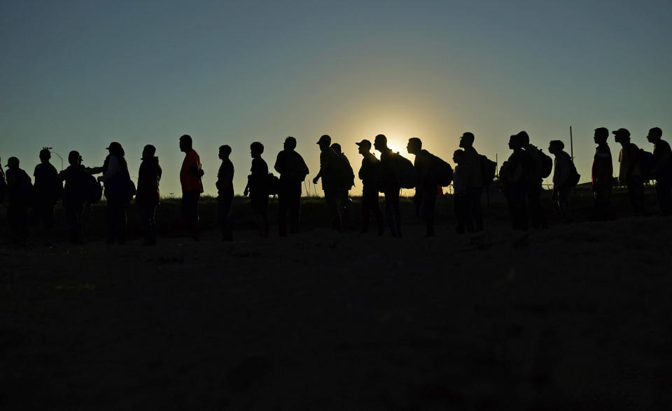 Migrants who crossed the Rio Grande and entered the U.S. from Mexico are lined up for processing by U.S. Customs and Border Protection on Sept. 23, 2023, in Eagle Pass, Texas.  (Eric Gay / AP file)