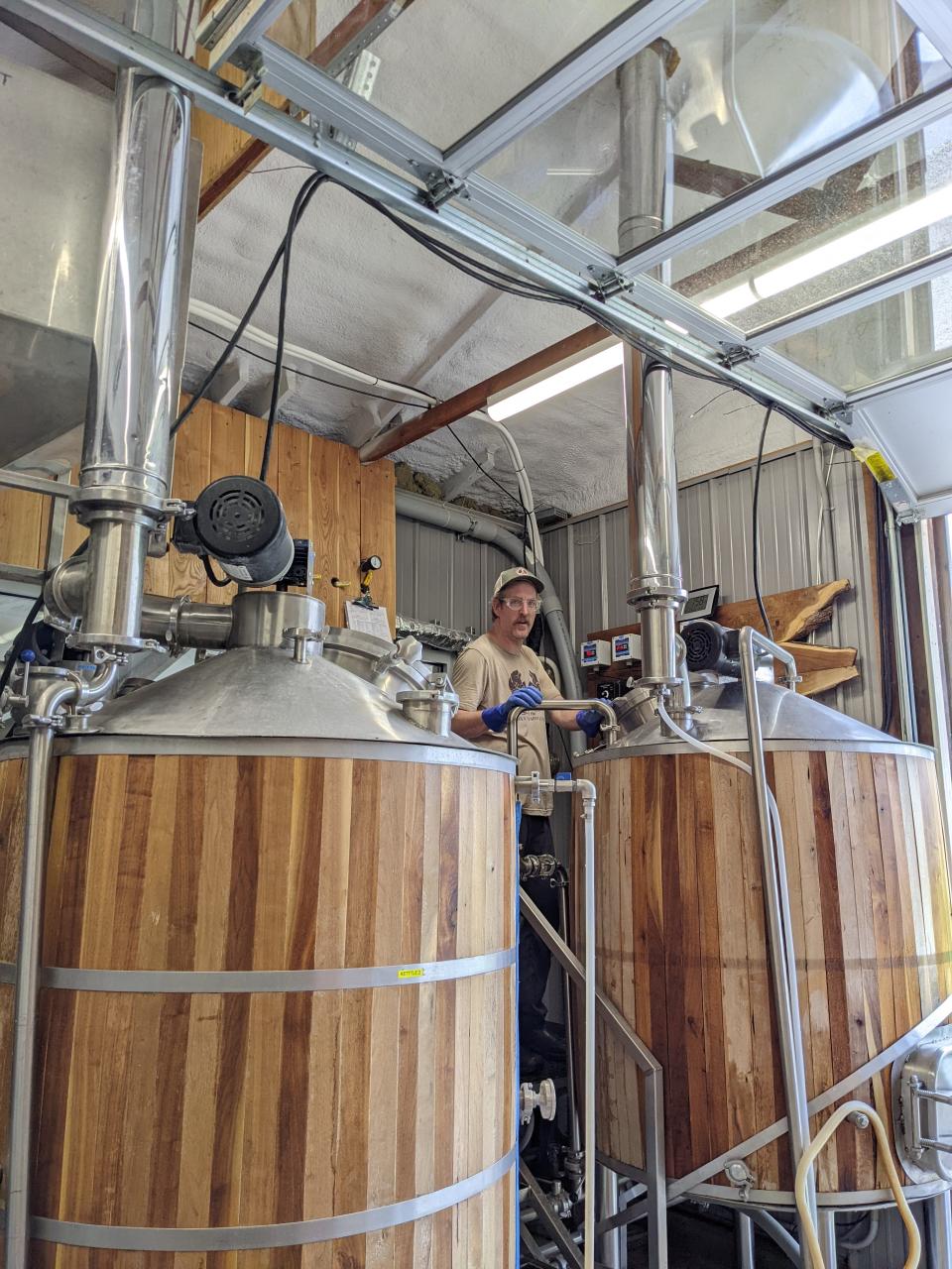 Dennis Wilson, brewer at the Wooly Pig, monitors the brewing process. A single brew produces about 150 gallons of beer and most brew days comprise two brews.  (Photo by Jael Malenke)