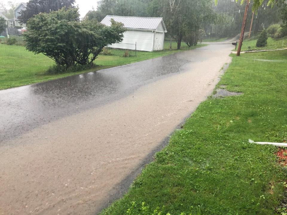 Water runoff covers much of a street in North Hornell Friday as the remnants of Tropical Storm Debby moved through the Southern Tier.