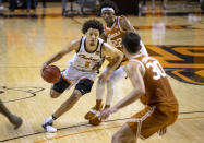FILE - In this Feb. 6, 2021, file photo, Oklahoma State guard Cade Cunningham (2) drives past Texas forward Kai Jones (22) and Brock Cunningham (30) during the first overtime of the NCAA college basketball in Stillwater, Okla. Cunningham is a 6-foot-8 ballhandler with the ability to play on or off the ball. He's widely expected to be the No. 1 NBA draft pick after one year with the Cowboys. (AP Photo/Mitch Alcala, File)