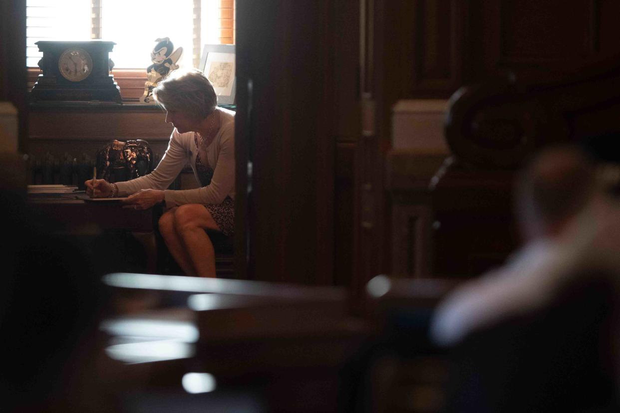 Rep. Barb Wasinger, R-Hays, writes Monday in a back office inside the House Chambers.