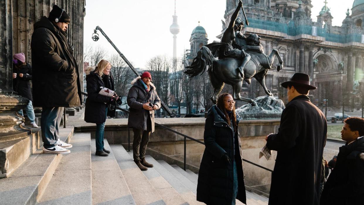 a group of people standing around a statue