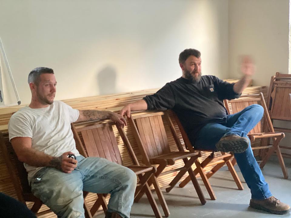 Alex Davis, 27, sits alongside pastor Daniel Adkins (Richard Hall / The Independent)