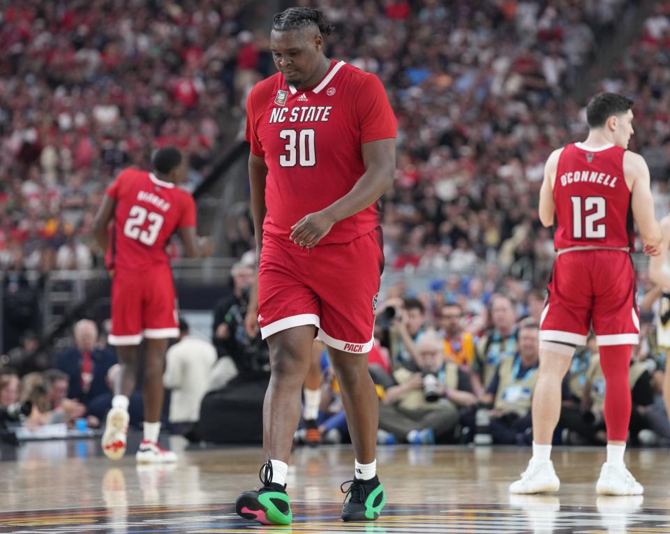 North Carolina State Wolfpack forward DJ Burns Jr. (30) walks back down court during the NCAA Menâ€™s Basketball Tournament Final Four game against the Purdue Boilermakers, Saturday, April 6, 2024, at State Farm Stadium in Glendale, Ariz.