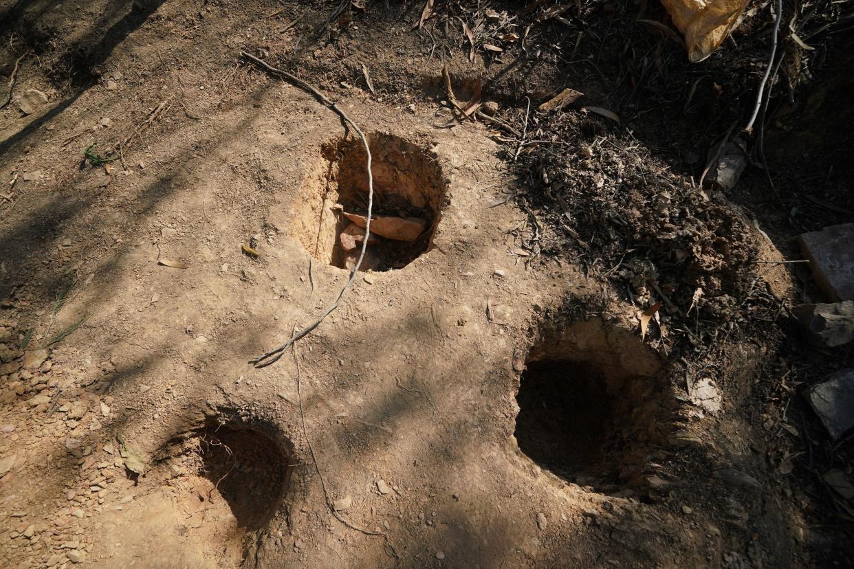 Holes dug apparently for soil samples in the area around Barragem do Arade reservoir, in the Algave, Portugal, after the area was reopened to media (PA)