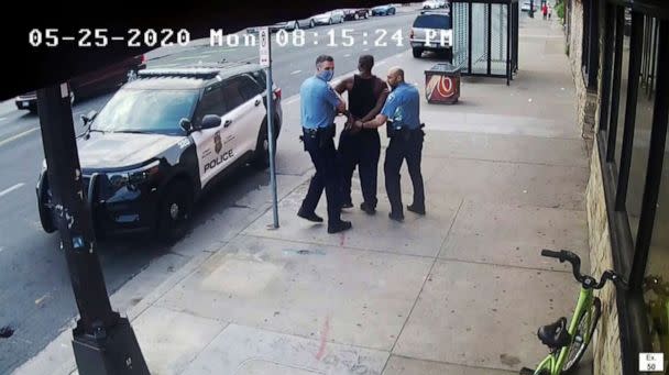 PHOTO: In an image from video, Minneapolis Police Officers Thomas Lane, left, and J. Alexander Kueng, right, escort George Floyd, center, to a police vehicle outside Cup Foods in Minneapolis, May 25, 2020. (Court TV via AP, File)