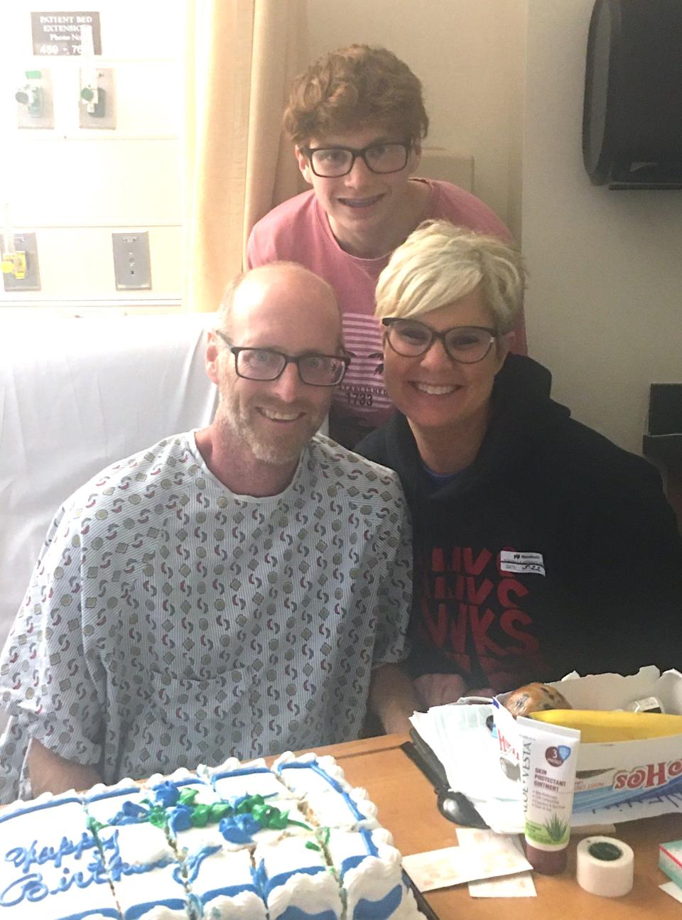 Nevin Mishler celebrates his 49th birthday in the hospital last summer with his wife Kari and their son Caleb.