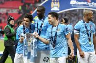 Manchester City goalscorers Gonzalez Jesus Navas (left), Yaya Toure and Samir Nasri (right) celebrate with the Capital One Cup trophy following victory over Sunderland 