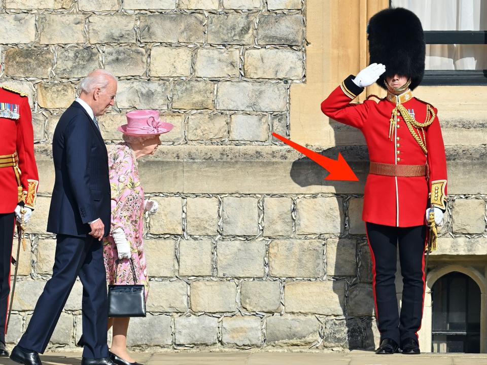 A royal guard salutes the Queen and President Joe Biden in 2021.