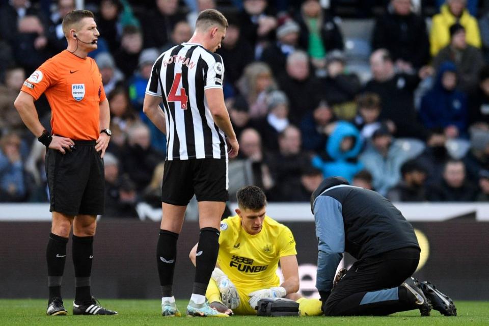 Newcastle United's English goalkeeper Nick Pope (2R) receives medical treatment during the English Premier League football match between Newcastle United and Fulham at St James'  Park in Newcastle-upon-Tyne, north-east England on January 15, 2023