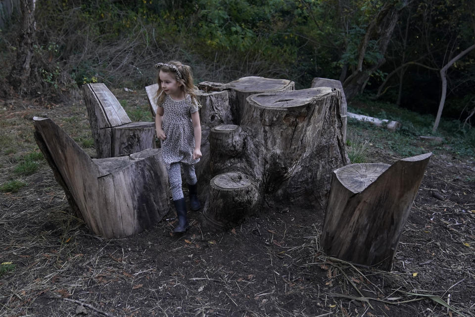 Aylah Levy, 6, walks through an area of Codornices Park, a location she attended as a Berkeley Forest School student, during an interview with her mother, Hannah, in Berkeley, Calif., Wednesday, Nov. 8, 2023. (AP Photo/Jeff Chiu)