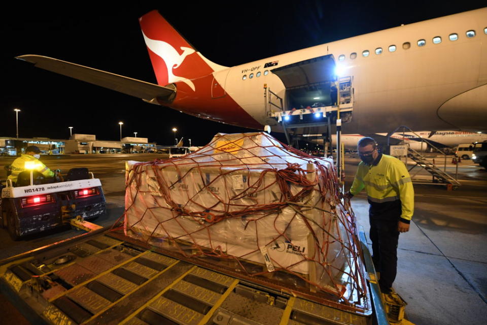 Pallets of vaccines being unloaded off Qantas flight QF110 from Darwin after landing at Kingsford Smith International Airport in Sydney, Australia. 