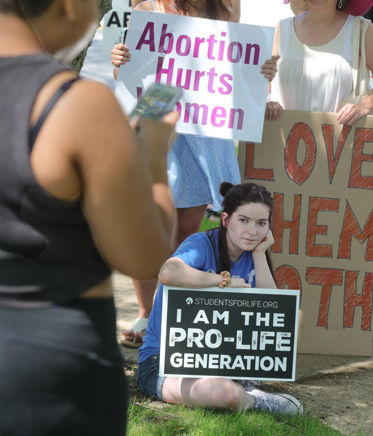 Anti-abortion advocate Elizabeth McGuire, 24, listens to event organizer Constance Hairston's speech Sunday at Croghan Park in Fairlawn.