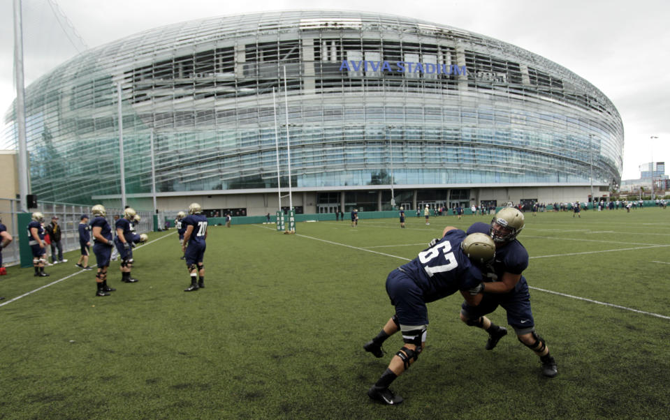 FILE - Navy football players training at the Aviva Stadium, Dublin, Ireland, Aug. 30, 2012. College football is going international again with Nebraska facing Northwestern in Dublin on Saturday Aug. 27, 2022. It's the first regular-season international game in five years. (AP Photo/Peter Morrison, File)