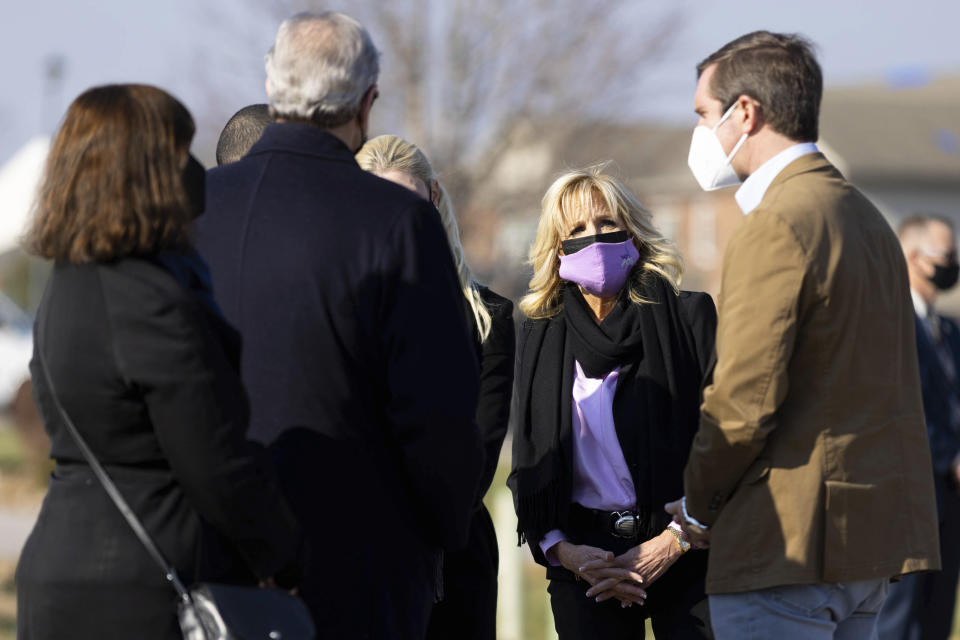 First lady Jill Biden listens to Kentucky Gov. Andy Beshear, right, while surveying the damage of a tornado that hit the Creekwood neighborhood in Bowling Green, Ky., Friday, Jan. 14, 2022. (AP Photo/Michael Clubb)