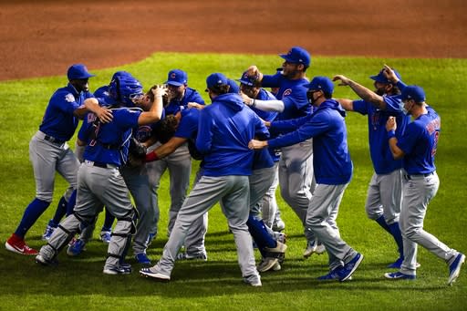 Chicago Cubs starting pitcher Alec Mills is swarmed by teammates after throwing a no hitter at a baseball game against the Milwaukee Brewers Sunday, Sept. 13, 2020, in Milwaukee. The Cubs won 12-0. (AP Photo/Morry Gash)