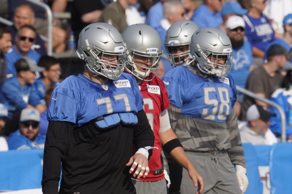 Detroit Lions offensive guard Frank Ragnow (77), quarterback Jared Goff (16) and offensive tackle Penei Sewell (58) warm up during an NFL football training camp practice in Allen Park, Mich., Saturday, July 31, 2021. (AP Photo/Paul Sancya)