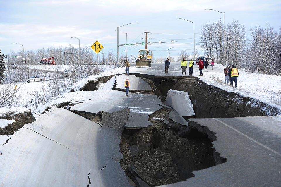 FILE - In this Nov. 30, 2018, file photo, workers inspect an off-ramp that collapsed during a morning earthquake in Anchorage, Alaska. Seven weeks after the massive earthquake struck Alaska, the seemingly endless aftershocks are keeping many residents filled with anxiety. (AP Photo/Mike Dinneen, File)