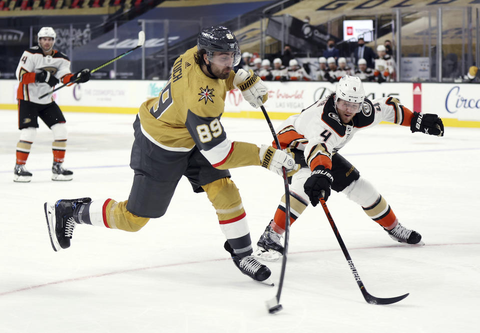 Vegas Golden Knights right wing Alex Tuch (89) shoots as Anaheim Ducks Cam Fowler (4) defends during the second period of an NHL hockey game Saturday, Jan. 16, 2021, in Las Vegas. (AP Photo/Isaac Brekken)