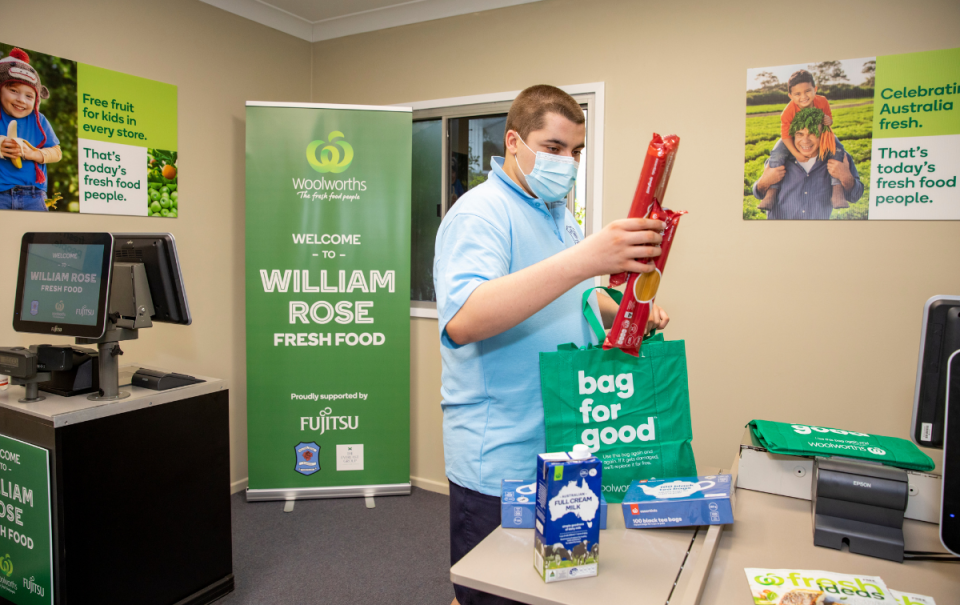 Student at Mini Woolworths school store